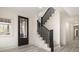 Inviting entryway with staircase, stylish front door, light floors, and modern finishes at 177 Olympia Dr, Mooresville, NC 28117