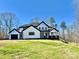 Stunning new construction home with black trim, bright white siding, and a covered porch at 177 Olympia Dr, Mooresville, NC 28117