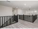 Open hallway area with black metal banisters and wood-look flooring at 177 Olympia Dr, Mooresville, NC 28117