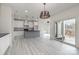 Bright, open kitchen with white cabinets, gray island, and stainless steel appliances at 177 Olympia Dr, Mooresville, NC 28117