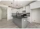 Modern kitchen with gray island, black countertops, and stainless steel appliances at 177 Olympia Dr, Mooresville, NC 28117