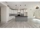 Well-lit kitchen showcasing a gray island, white cabinets, and modern pendant lighting at 177 Olympia Dr, Mooresville, NC 28117