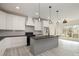 Modern kitchen with gray island, black countertops, and stainless steel gas range at 177 Olympia Dr, Mooresville, NC 28117