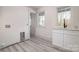 Laundry room features a sink, white cabinets and luxury vinyl plank flooring at 177 Olympia Dr, Mooresville, NC 28117