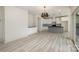 Open floor plan featuring a kitchen with a gray island and white cabinets and an adjacent living area at 177 Olympia Dr, Mooresville, NC 28117