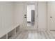 Bright mud room showcasing a bench, a glass-paneled exterior door, and wood-look flooring at 177 Olympia Dr, Mooresville, NC 28117