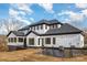 Exterior rear elevation showcasing a modern farmhouse with a walkout and screened in porch on a large lot at 177 Olympia Dr, Mooresville, NC 28117