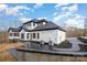 Rear exterior view of a modern farmhouse with black accents, a walkout and a concrete patio at 177 Olympia Dr, Mooresville, NC 28117