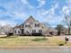 Charming two-story home with manicured lawn, mature trees and brick mailbox in a desirable neighborhood at 18808 Coveside Ln, Cornelius, NC 28031