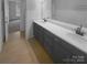 Double vanity bathroom with a view into a bedroom at 2124 Electric Ln, Charlotte, NC 28205