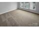 Bright bedroom with neutral carpet and large windows at 2124 Electric Ln, Charlotte, NC 28205