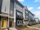 Modern townhomes with gray and blue siding and yellow doors at 2124 Electric Ln, Charlotte, NC 28205