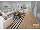 Virtually staged living room with striped rug and modern furniture at 2124 Electric Ln, Charlotte, NC 28205
