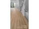 Light hardwood floors in open living space with fireplace at 2124 Electric Ln, Charlotte, NC 28205