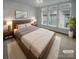 Spacious bedroom with large windows and wood platform bed at 2124 Electric Ln, Charlotte, NC 28205