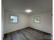 Well-lit bedroom featuring wood-look flooring and large windows at 2334 Woodleaf Dr, Gastonia, NC 28052