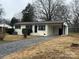 Brick ranch home with covered porch and gravel driveway at 2334 Woodleaf Dr, Gastonia, NC 28052