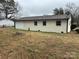 Rear view of brick ranch home with new paint and black trim at 2334 Woodleaf Dr, Gastonia, NC 28052