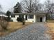 Charming ranch home with updated exterior and gravel driveway at 2334 Woodleaf Dr, Gastonia, NC 28052