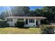 Charming white brick home with a well-maintained lawn and covered carport, perfect for outdoor living at 2334 Woodleaf Dr, Gastonia, NC 28052
