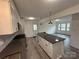 Modern kitchen with island, white cabinets, and stainless steel appliances at 2334 Woodleaf Dr, Gastonia, NC 28052