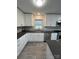Modern kitchen with white cabinets, dark countertops, and stainless steel appliances at 2334 Woodleaf Dr, Gastonia, NC 28052