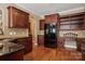 Kitchen with dark wood cabinets, granite counters, and built-in desk at 2608 Golden Bell Dr, Gastonia, NC 28056