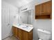 Bathroom with double vanity, wood cabinets, and a mirrored medicine cabinet at 3522 Larkhaven Village Dr, Charlotte, NC 28215