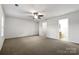Bedroom with ceiling fan, carpet, and ensuite bathroom access at 3522 Larkhaven Village Dr, Charlotte, NC 28215