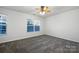 Bright bedroom with ceiling fan, carpet, and large window at 3522 Larkhaven Village Dr, Charlotte, NC 28215