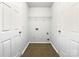 Laundry room with washer and dryer hookups, shelving and tile floor at 3522 Larkhaven Village Dr, Charlotte, NC 28215