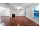 Spacious living room featuring hardwood floors and a corner fireplace at 3522 Larkhaven Village Dr, Charlotte, NC 28215