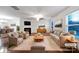 Virtually staged living room with fireplace and neutral-toned furniture at 3522 Larkhaven Village Dr, Charlotte, NC 28215