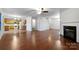 Open living room with kitchen, fireplace, and hardwood floors at 3522 Larkhaven Village Dr, Charlotte, NC 28215