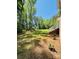Expansive backyard with a gentle slope, mature trees, and a view of the home's exterior at 395 Paulownia Dr, China Grove, NC 28023