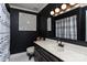 Stylish bathroom with dark walls, a white sink and patterned shower curtain at 395 Paulownia Dr, China Grove, NC 28023