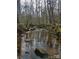 Serene creek running through a wooded area at 395 Paulownia Dr, China Grove, NC 28023