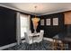 Bright dining area with a glass table, four chairs, and stylish light fixture at 395 Paulownia Dr, China Grove, NC 28023