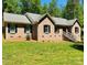 Lovely brick home with a well-manicured lawn and traditional architectural details at 395 Paulownia Dr, China Grove, NC 28023