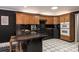 Modern kitchen with dark cabinets and geometric tile floor at 395 Paulownia Dr, China Grove, NC 28023