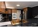 Modern kitchen features dark cabinetry, stainless steel appliances, and a gold sink at 395 Paulownia Dr, China Grove, NC 28023