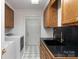 Laundry room with washer, dryer, and a modern black and gold sink at 395 Paulownia Dr, China Grove, NC 28023