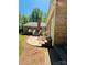 Back exterior of a home featuring a brick facade, multiple access points and stairs at 395 Paulownia Dr, China Grove, NC 28023
