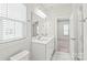 Bathroom with double vanity and access to bedroom at 448 E 16Th St, Charlotte, NC 28206