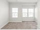 Bright bedroom with neutral carpeting and two windows at 448 E 16Th St, Charlotte, NC 28206