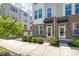 Charming townhome featuring brick accents, a welcoming entryway, and manicured landscaping at 448 E 16Th St, Charlotte, NC 28206