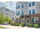 Charming townhome featuring brick accents, a welcoming entryway, and manicured landscaping at 448 E 16Th St, Charlotte, NC 28206