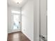 Bright foyer with hardwood floors, a modern white door, and pristine white walls at 448 E 16Th St, Charlotte, NC 28206