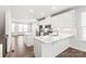 Open concept kitchen with island, white cabinets and hardwood floors at 448 E 16Th St, Charlotte, NC 28206