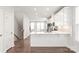 Open concept kitchen with island, white cabinets, and hardwood floors at 448 E 16Th St, Charlotte, NC 28206
